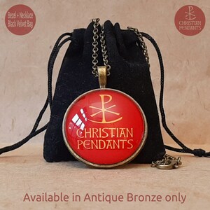 May include: Antique bronze pendant necklace with a red circular pendant featuring a gold Christian symbol and the words "CHRISTIAN PENDANTS." The necklace is displayed with a black velvet bag. The text "Available in Antique Bronze only" is also visible.