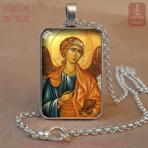 May include: Antique silver bezel necklace featuring a religious icon of an angel with a gold halo. The angel is depicted with wings, holding a small box and an arrow. The text "Raphael" is visible. The necklace has a silver chain.