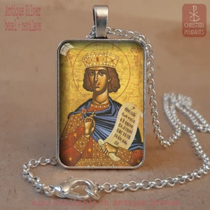 May include: Antique silver bezel necklace featuring a religious icon. The pendant displays a detailed illustration of a saint with a crown, holding a scroll. The chain is a silver-colored, linked design. The text "Antique Silver bezel + necklace" is visible.