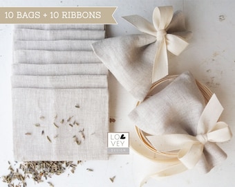 May include: A collection of ten linen bags and ten ribbons. The bags are a natural beige color, some filled with dried lavender. Two bags are tied with cream-colored ribbons. The text "10 BAGS + 10 RIBBONS" is at the top.