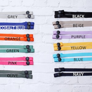 May include: A set of 10 different colored mask extenders with adjustable black plastic sliders. The colors are grey, cobalt blue, orange, green, pink, olive, black, beige, purple, yellow, blue, and navy.