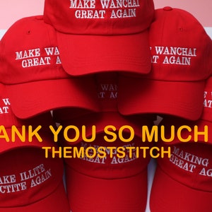 May include: A stack of red baseball caps with white embroidered text. The text on the caps reads "MAKE WANCHAI GREAT AGAIN", "MAKE WA GREAT A", "MAKE ILLITE SMECTITE AGAIN", and "MAKING IAA GREAT AGAIN". The image also includes the text "THANK YOU SO MUCH !! :) THEMOSTSTITCH".