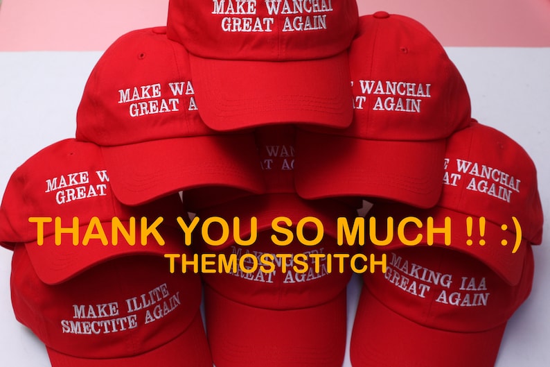 May include: A stack of red baseball caps with white embroidered text. The text on the caps reads "MAKE WANCHAI GREAT AGAIN", "MAKE WA GREAT A", "MAKE ILLITE SMECTITE AGAIN", and "MAKING IAA GREAT AGAIN". The image also includes the text "THANK YOU SO MUCH !! :) THEMOSTSTITCH".