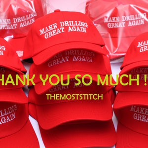 May include: Red baseball caps with the text "MAKE DRILLING GREAT AGAIN" in white. The caps are stacked and arranged, with the phrase "THANK YOU SO MUCH !! :)" and the seller's name, "themoststitch", in the image.