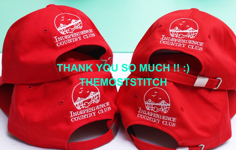 May include: Red baseball caps with white embroidered text and a circular logo that reads "INDEPENDENCE COUNTRY CLUB." The caps have adjustable straps and a curved brim. The text "THANK YOU SO MUCH !! :) THEMOSTSTITCH" is also visible.