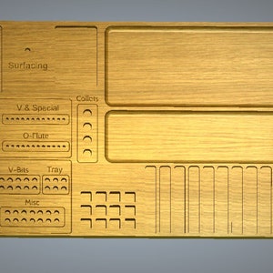May include: A wooden organizer with labeled compartments for storing various tools, including surfacing tools, collets, V-bits, and a tray. The organizer has a light brown wood finish.
