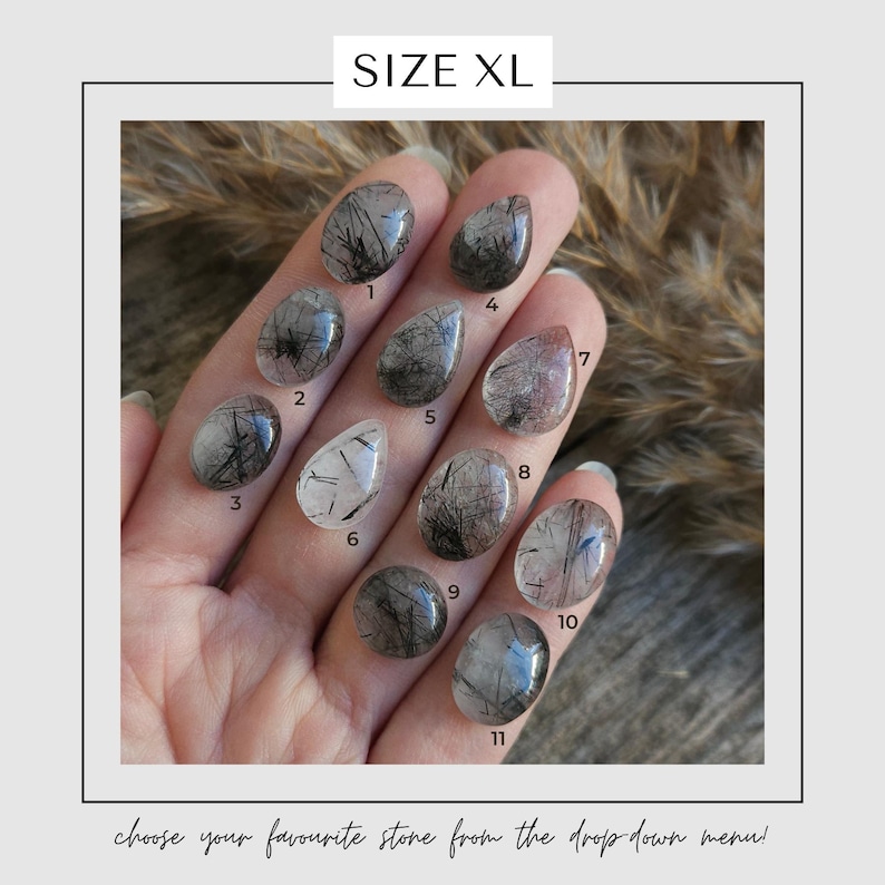 May include: A hand displays eleven XL-sized, polished gemstones. Each stone is a different shape and features black inclusions within a clear or translucent base. The text "SIZE XL" is at the top, and "choose your favourite stone from the drop down menu!" is at the bottom.