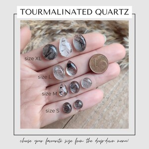 May include: The image displays various sizes of tourmalinated quartz stones, ranging from XL to S. The stones are clear with black inclusions, and a coin is included for size comparison. Text reads "TOURMALINATED QUARTZ" and "choose your favourite size from the drop down menu!"