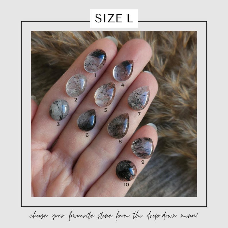 May include: A hand displays ten polished, clear quartz stones with black inclusions, each numbered. The stones vary in shape, including oval and teardrop. The text "SIZE L" is at the top, and the text "choose your favourite stone from the drop down menu!" is at the bottom.