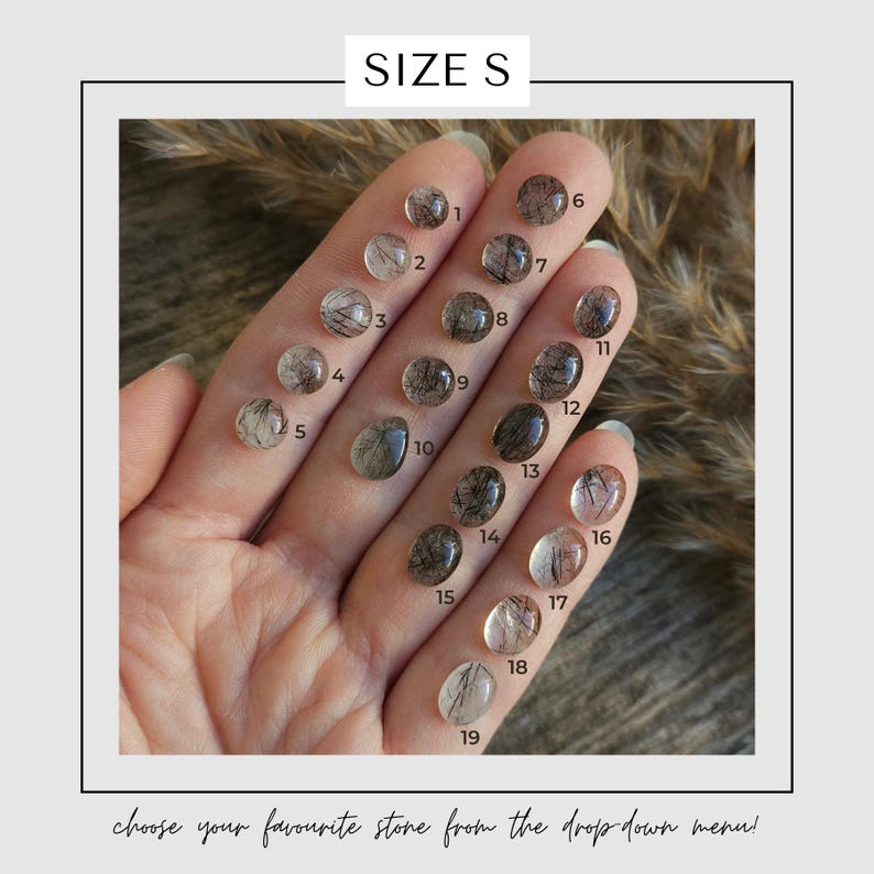 May include: A selection of nineteen small, oval-shaped stones with inclusions, numbered 1 through 19, are displayed on a hand. The stones vary in color, with some appearing clear and others featuring dark, hair-like inclusions. The text "SIZE S" is at the top.