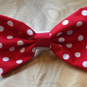 May include: Red bow tie with white polka dots.