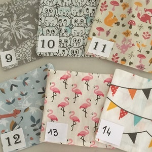 May include: Ten fabric squares with different patterns, numbered 9 through 14. The patterns include palm trees, cats, squirrels, mushrooms, flamingos, and bunting.