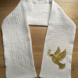 May include: White cotton scarf with a gold peace dove design. The dove is holding an olive branch in its beak.