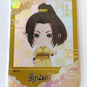 May include: A trading card featuring an anime-style character with dark hair and a yellow outfit. The card has a gold and cream background with Japanese text and a QR code. The character has a small red dot on their forehead.