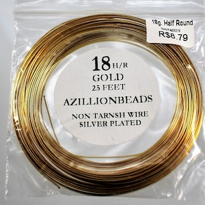 May include: A spool of 18 gauge gold-plated wire, 25 feet long, for jewelry making. The wire is half round and non-tarnish. The label reads "18 H/R GOLD 25 FEET AZILLIONBEADS NON TARNSH WIRE SILVER PLATED".