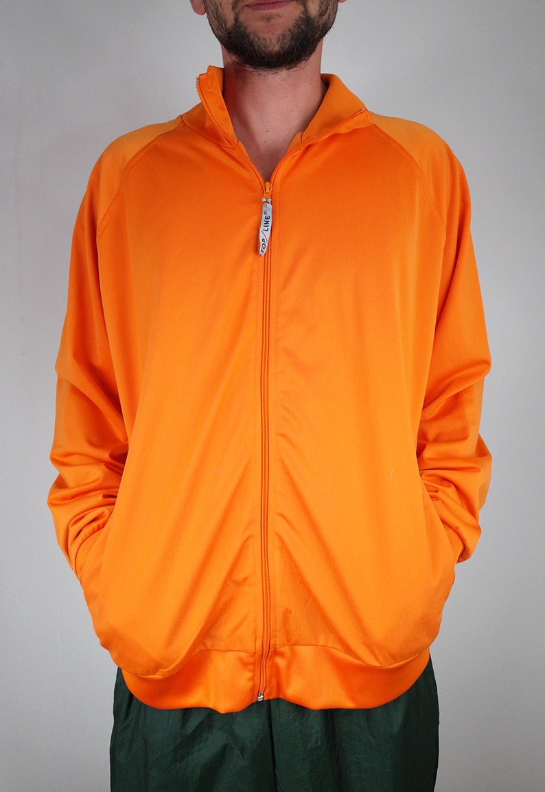 haut de survêtement vintage, veste de survêtement, coupe vent vintage des années 90, survêtement zippé orange, veste de jogging sport de gymnastique, haut de survêtement vintage, veste de survêtement, coupe vent vintage des années 90, survêtement zippé orange, veste de jogging sport de gymnastique,