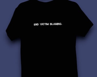 May include: Black t-shirt with the text "END VICTIM BLAMING." printed in white on the front.