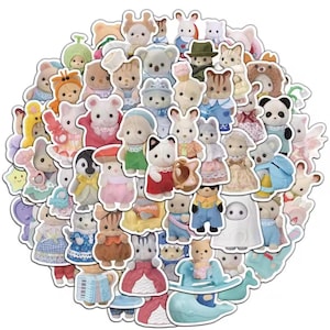 May include: A circular arrangement of colourful animal character stickers, including bears, bunnies, cats, and penguins. The stickers feature various outfits and accessories, creating a whimsical aesthetic. The stickers are die-cut with white borders.