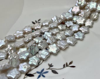 Peut inclure: Un brin de perles blanches en forme d'étoiles. Les perles ont un éclat iridescent.