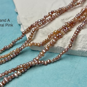 May include: Strand A natural pink pearl necklace. The necklace features multiple strands of small, irregularly shaped pearls in shades of pink, peach, and cream. The pearls are strung together, creating a delicate and elegant accessory.