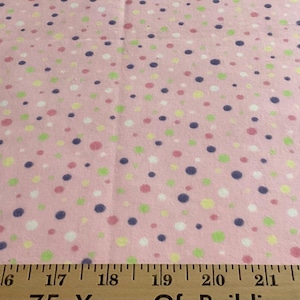 Flannel/Multi-colored polka dots on pink background cotton fabric