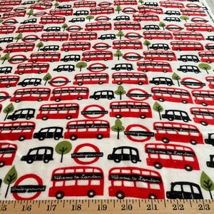 Flannel/London busses and cabs on white background cotton fabric