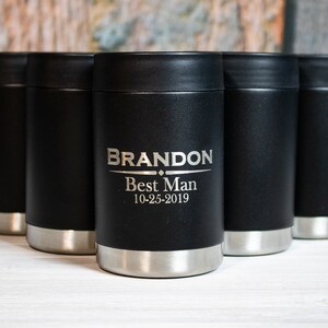 May include: Five black and silver insulated beverage holders with a personalized inscription that reads "BRANDON Best Man 10-25-2019".