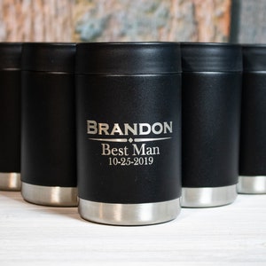 May include: Five black and silver insulated beverage holders with a personalized inscription that reads "BRANDON Best Man 10-25-2019".