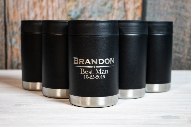 May include: Five black and silver insulated beverage holders with a personalized inscription that reads "BRANDON Best Man 10-25-2019".