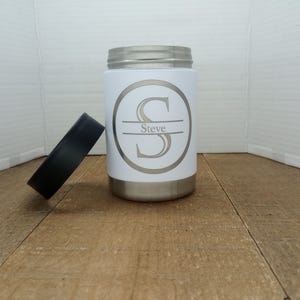 May include: White stainless steel can cooler with a black lid. The cooler features a personalised design with the letter "S" and the name "Steve" printed on it.