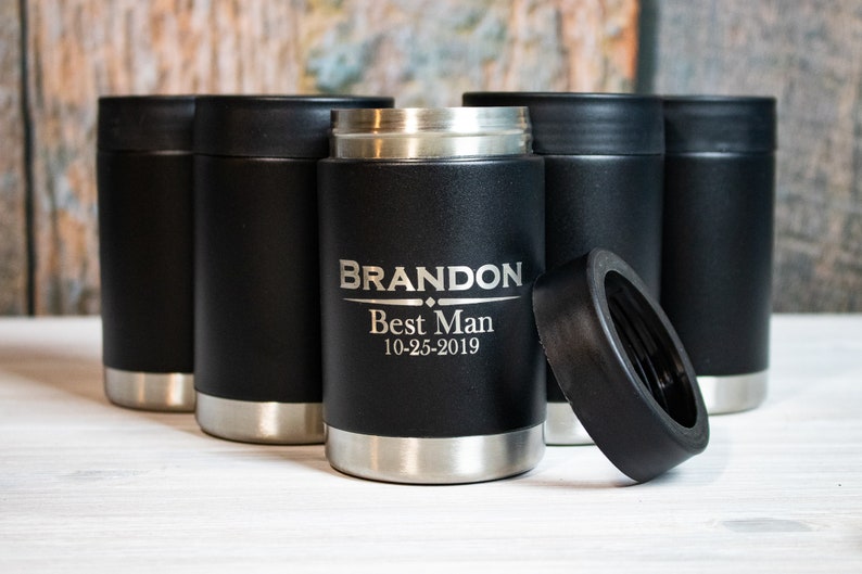 May include: Six black and silver insulated beverage holders with a black lid. One holder is engraved with the text "BRANDON Best Man 10-25-2019".
