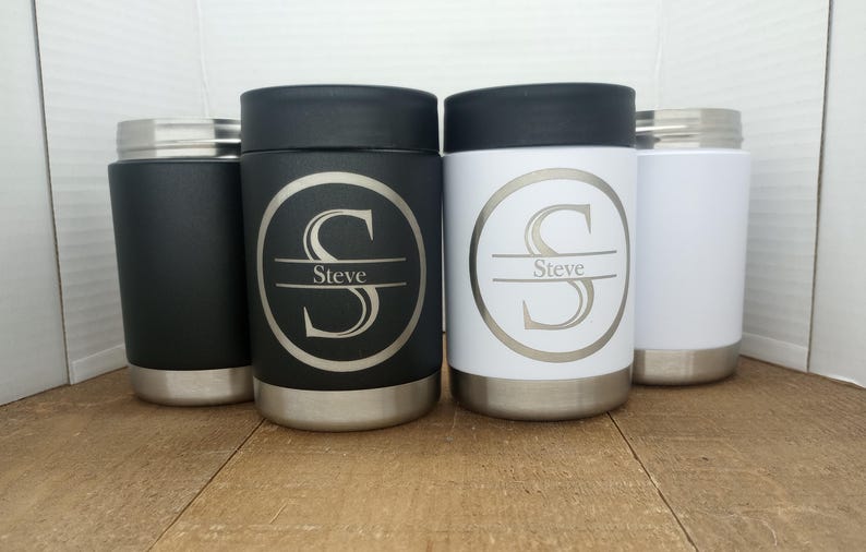 May include: Three stainless steel can coolers with a black, white and silver finish. Each cooler has a personalised design with the letter "S" and the name "Steve" engraved on it.