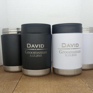 May include: Four stainless steel tumblers with lids. Two tumblers are black with the name "DAVID" and the text "Groomsman 3.13.2021". Two tumblers are white with the same text.