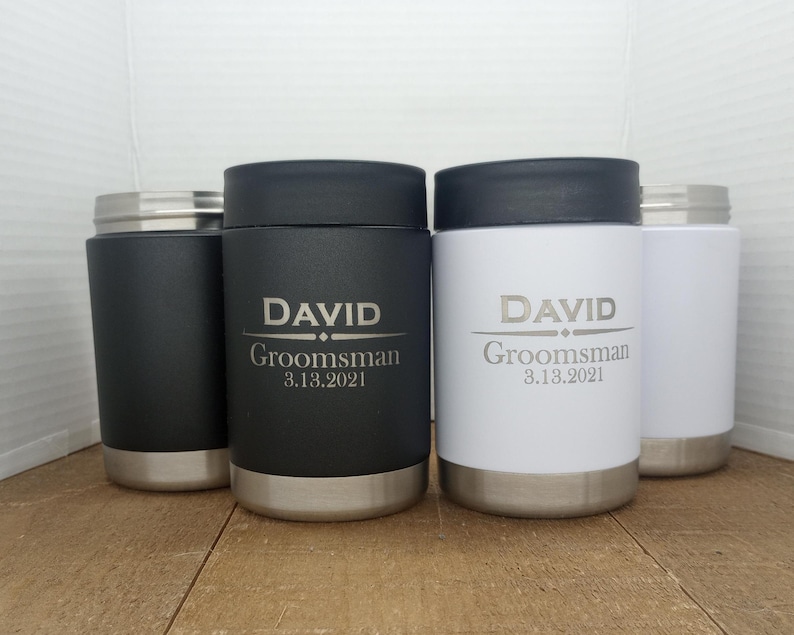 May include: Four stainless steel tumblers with lids. Two tumblers are black with the name "DAVID" and the text "Groomsman 3.13.2021". Two tumblers are white with the same text.