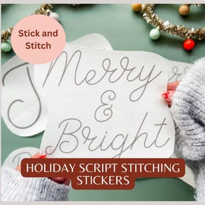 May include: White stickers with gray script lettering that reads "Merry & Bright" and "Joy". The stickers are labeled "Stick and Stitch" and "Holiday Script Stitching Stickers". The background is a muted green.