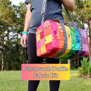 May include: A patchwork duffle bag with a rainbow pattern and black straps. The bag is made from a variety of colorful fabrics and has a quilted design. The text "Patchwork Duffle Fabric Kit" is printed on a pink and yellow background.