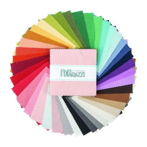 May include: A collection of 42 fabric squares in a variety of colors, arranged in a circle. The squares are all the same size and have a textured surface. The fabric is labeled "Poparazzi by The Red  Designers".