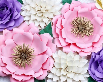 May include: A collection of paper flowers in various shades of pink, purple, and white. The flowers are made of paper and have a layered, three-dimensional appearance. The flowers are arranged in a cluster, creating a beautiful and delicate display.