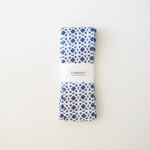 May include: A blue and white patterned fabric with a white label that says "SUMMER & JOY" in black text.