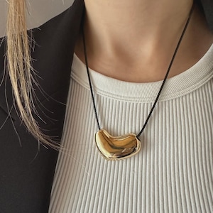 Gold Bean Pendant Necklace: 18k Gold Plated Stainless Steel + Adjustable Cord