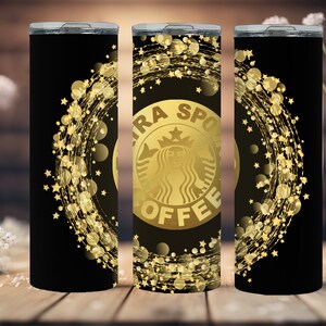 May include: Three black and gold stainless steel tumblers with a gold glitter design and the words "Extra Spoil Coffee" on the center tumbler.