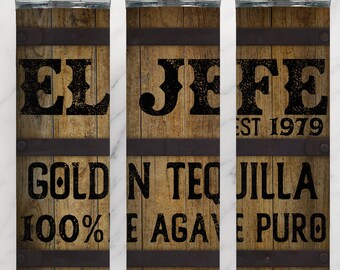 May include: A brown and black tumbler with the text "EL JEFE EST 1979 GOLD N TEQUILLA 100% E AGAVE PURO" on it. The tumbler has a wood grain pattern and metal bands.