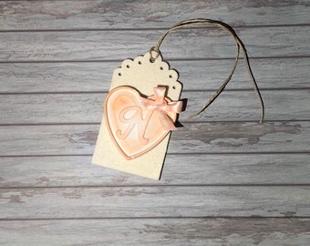 Tags with chalk-shaped heart and initial