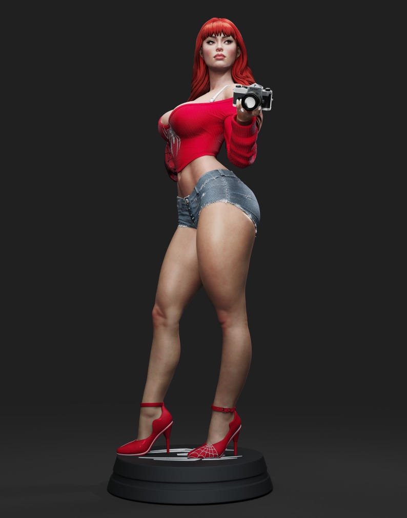 May include: A statue of a woman with red hair, wearing a red top, denim shorts, and red high heels. She is holding a camera. The heels have a spiderweb design. The statue is on a black base.