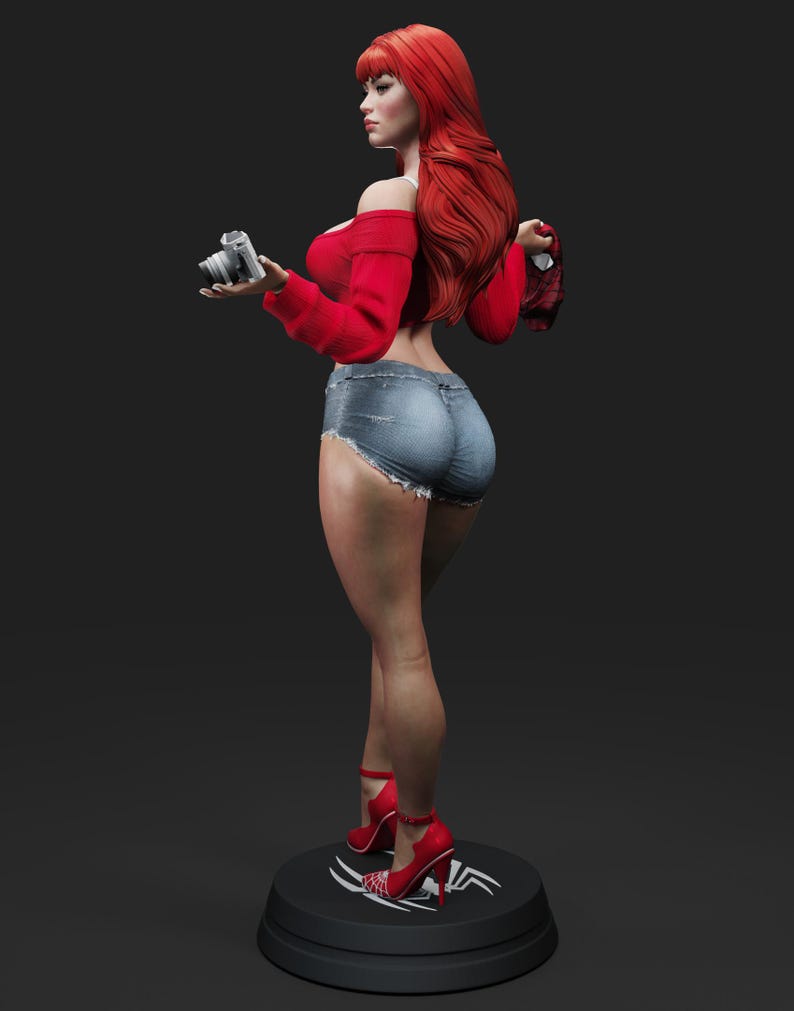 May include: A figurine of a woman with long red hair, wearing a red off-the-shoulder top, denim shorts, and red high heels. She holds a silver camera and stands on a black base with a white design.