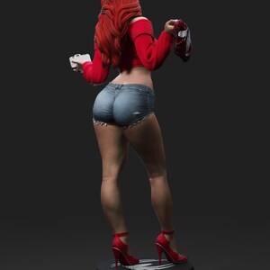 May include: A figurine of a person with long red hair, wearing a red off-the-shoulder top, denim shorts, and red high heels. The figure is holding a small white object and a red and black object. The figurine is standing on a black base.