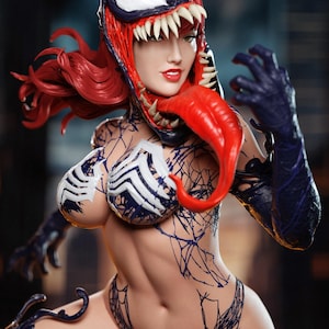 May include: A detailed figurine of a female character in a Venom-inspired costume. The figure features a red and black color scheme, with a large, open-mouthed headpiece, red hair, and a long red tongue. The costume includes a white and blue patterned top and intricate black web-like designs.