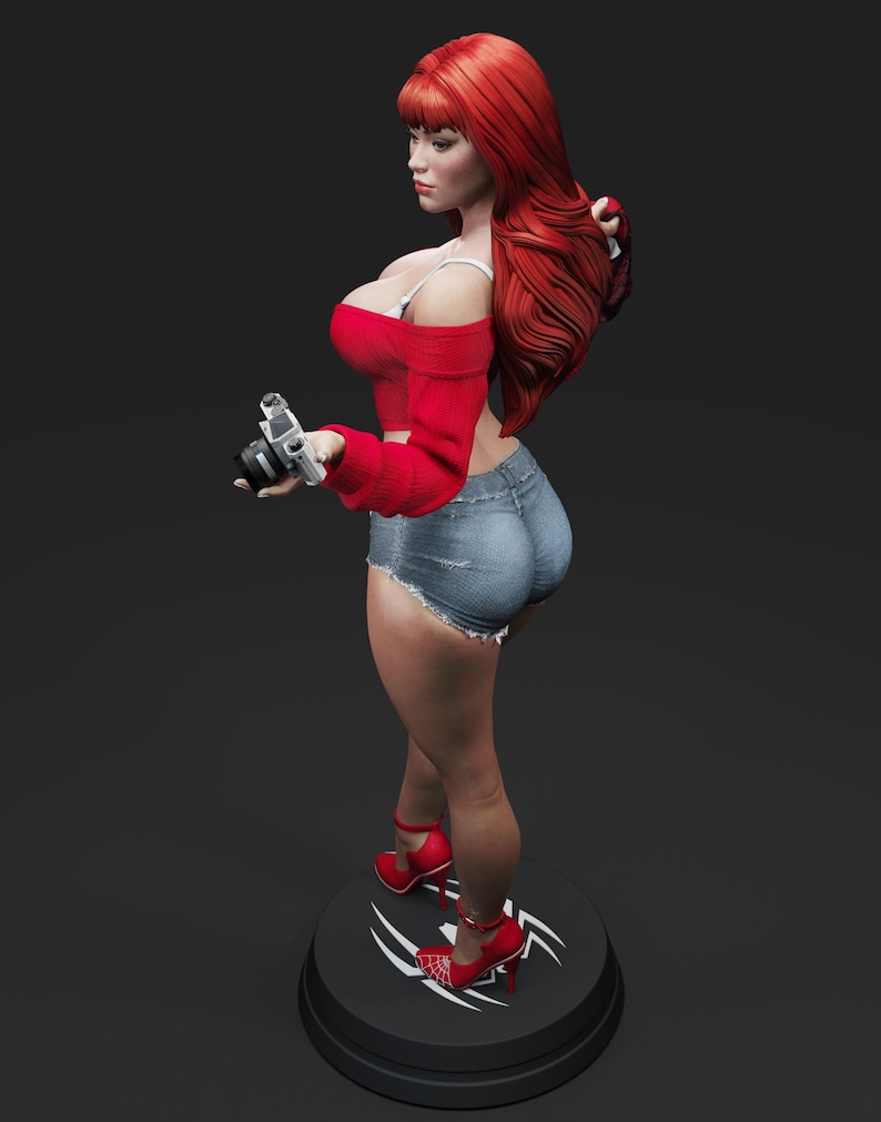 May include: A figurine of a woman with long red hair, wearing a red off-the-shoulder top, denim shorts, and red high heels. She is holding a silver camera. The figurine is standing on a black base with a white design.