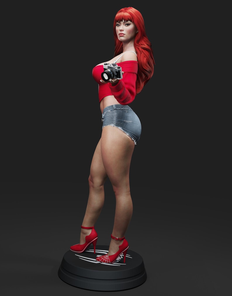 May include: A statue of a woman with long red hair, wearing a red off-the-shoulder top, denim shorts, and red high heels. She holds a vintage camera. The statue stands on a black base with a white design.