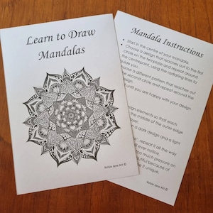 May include: Two cards with instructions on how to draw mandalas. The first card has a black and white mandala design. The second card has instructions on how to draw a mandala, including starting in the center and working outwards.